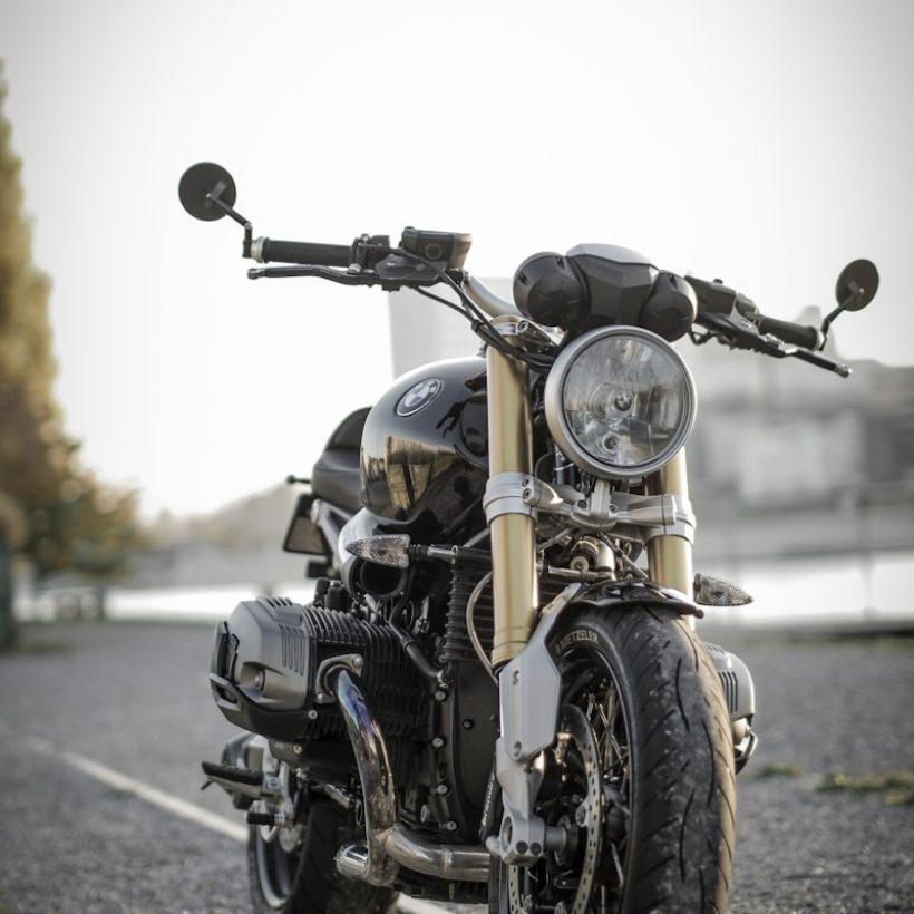 black bobber bike parked on road during daytime